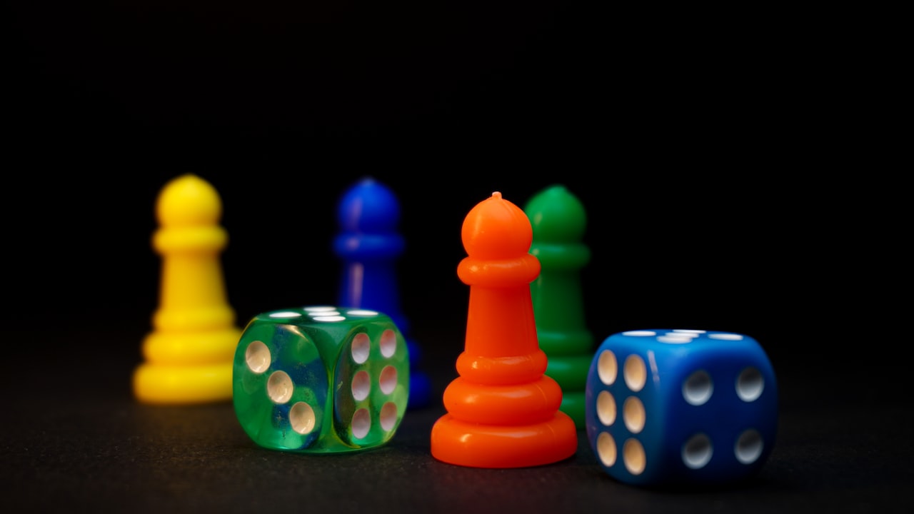 Polyhedral dice and painted tokens arranged on a wooden tabletop, ready to play